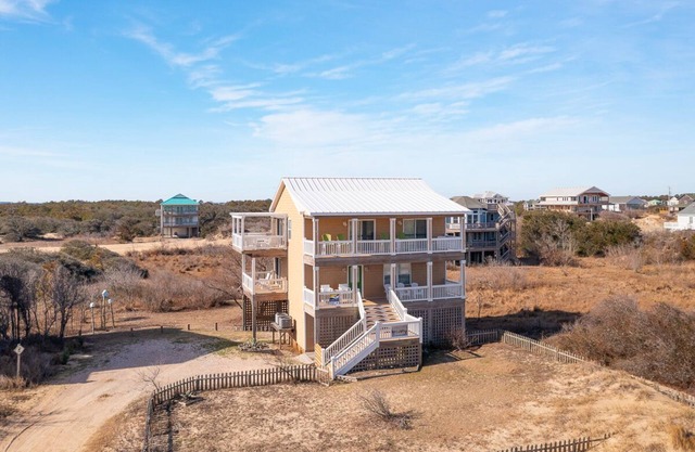 Relax among the dunes and see wild horses from the porch at Shifting Sands!