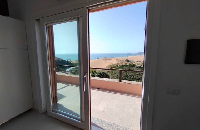 Renovated house overlooking dunes and pristine sea.