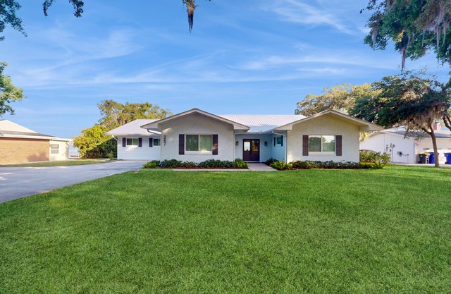 Renovated lakefront retreat with screened pool, private dock, patio, grill & W/D