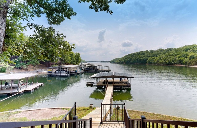 Renovated lakefront home with dock/water access, game room, decks & grill