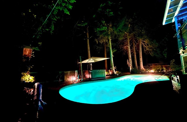 Resort Style home living w/Hottub , outdoor shower and heated pool.