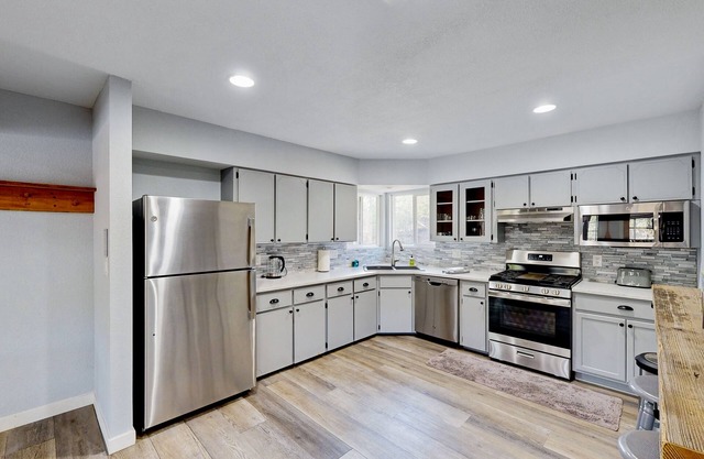 Riverfront charmer with sunroom, gas grill, games, smart TVs, W/D, & partial AC