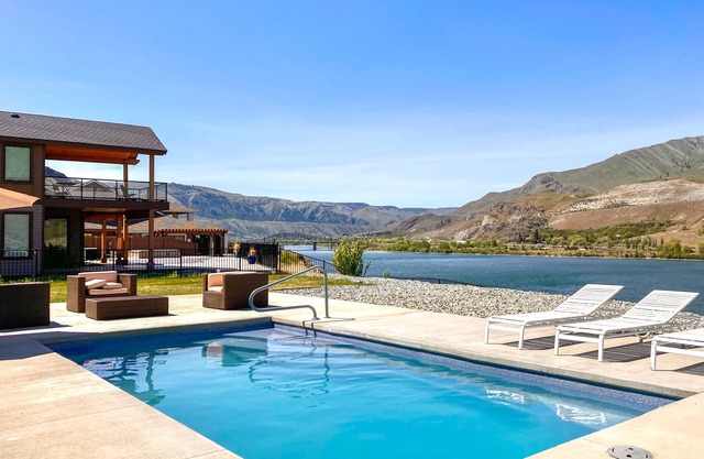 Luxury riverfront home near Chelan with game room, private pool, hot tub & suite