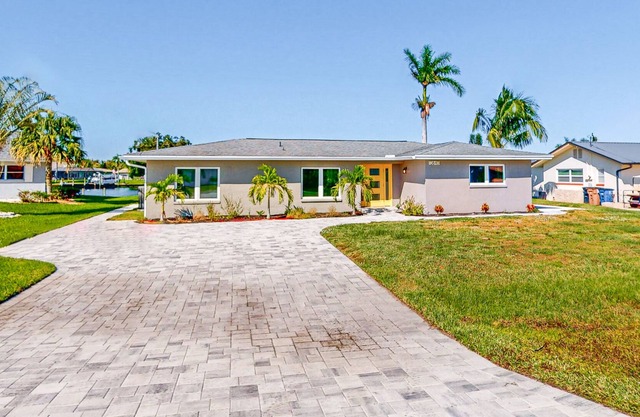 Riverfront home with beautiful views, private pool, screened lanai, grill, & W/D