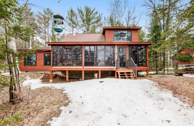 Riverfront vacation home with a dock, wood stove, full kitchen, & firepit