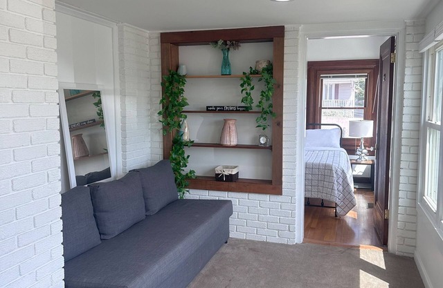 Room fully furnished with a comfortable bed and a modern sofa bed and plenty of natural light,
