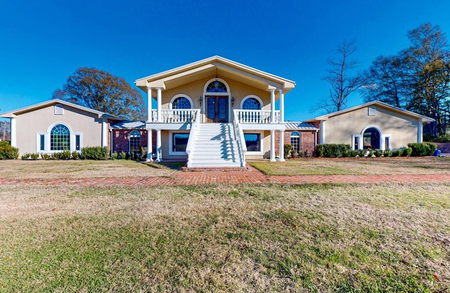 Secluded acreage with six bedrooms, pool, wood fireplace, ponds, grill, & AC