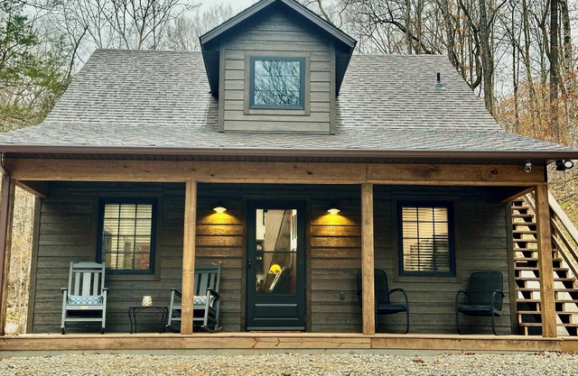 Secluded cabin next to creek with hot tub + fire pit. Walking distance to river.