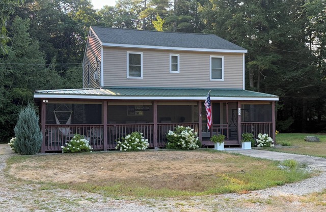Secluded lake house with water access to Lake Winni via brook in back yard.