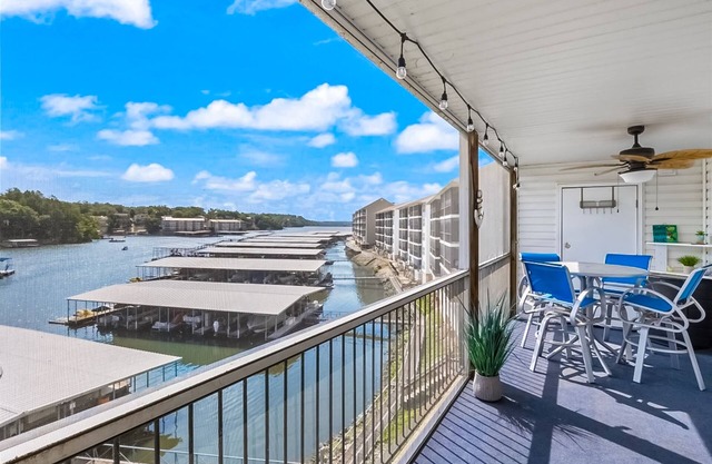 Single-level lake-view condo with dock, outdoor pool, washer/dryer, & central AC
