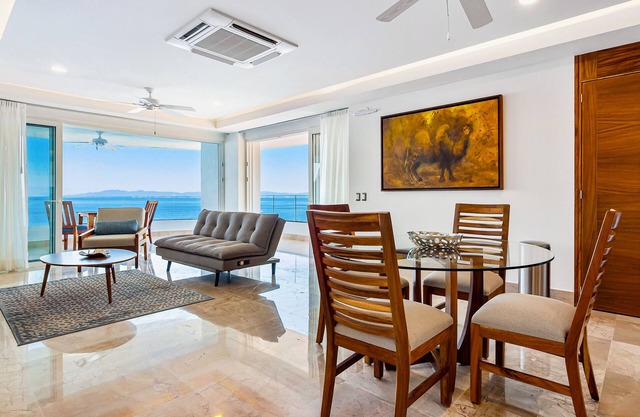Sleek 9th-floor condo with wraparound balcony, ocean views & pool