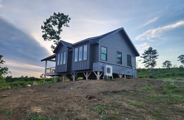 Small cottage house, centered on 100 acres surround by hills, lake, and cattle.