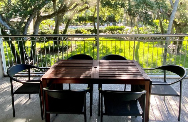 Spacious condo with views of oak canopy, gardens & pool. 5-minute walk to beach.