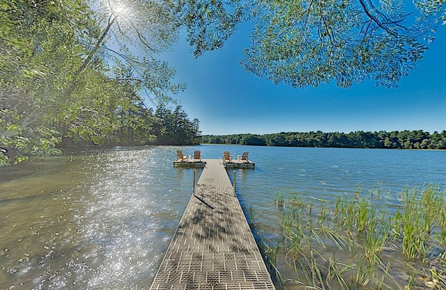 Spacious lakefront home on lush 5-acre lot with sunny deck & private dock