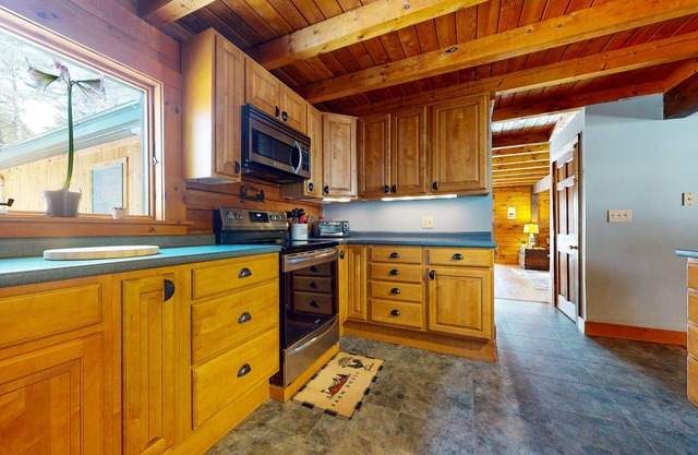 Spacious retreat with private hot tub, game room, deck, fireplace, & W/D