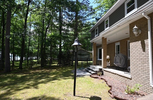 Spacious vacation home on large private wooded lot on crystal clear Hubbard Lake
