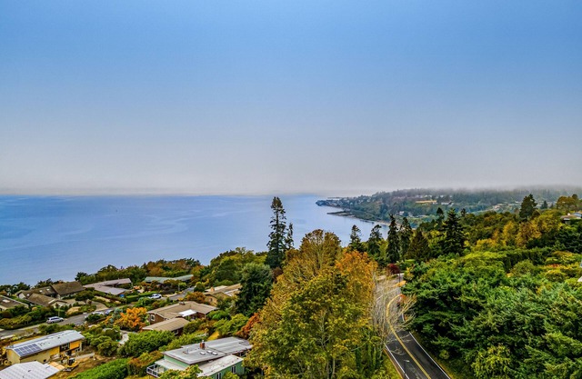 Spectacular mid-century home with two-story fireplace, huge deck, & water views