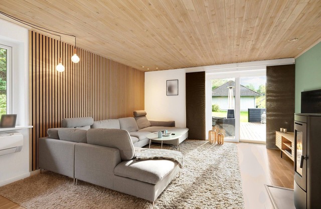 Spend your vacation in this beautiful vacation home with a large wooden terrace near Ebeltoft.