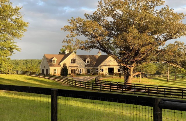 Stunning farmhouse in private, gated equestrian community.