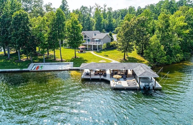 Stunning home w/sand beach, flat yard for games, dock w/ living area and bar!