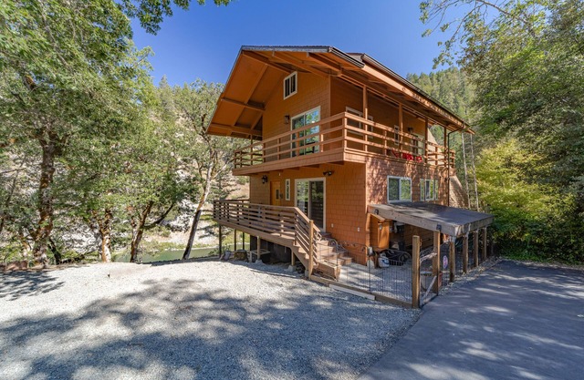 Stunning riverfront gem w/ wraparound deck, beach access & game room