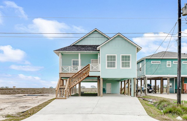 Sunset-view getaway with a wrap-around balcony, firepit, central AC, & W/D