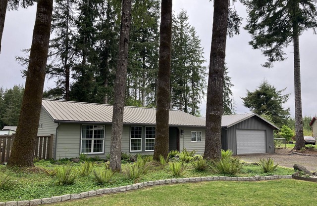 Surrounded by trees, this 3-bedroom, fully stocked retreat sleeps 8.