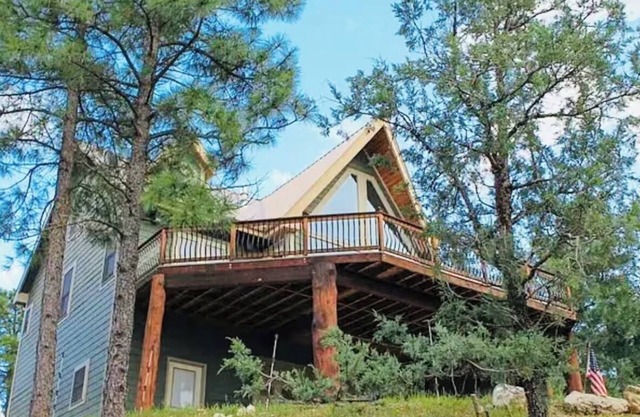 This is a luxurious two-story mountain retreat tucked in Ruidoso Downs, NM.