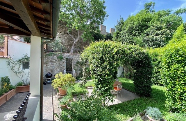 Top floor with garden bordering the historic city walls in San Niccolò district.
