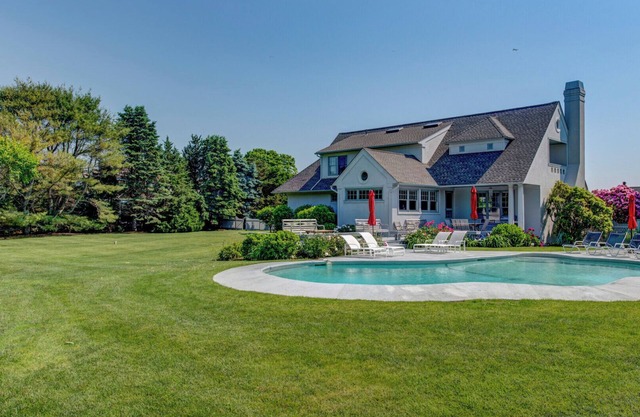 Traditional-style home with private pool, sweeping back deck, grand lawn,...