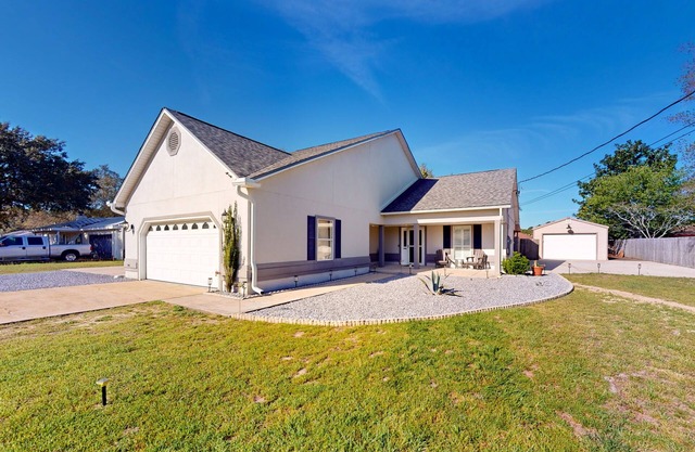 Trendy home with huge backyard, private hot tub, screened porch, & game room