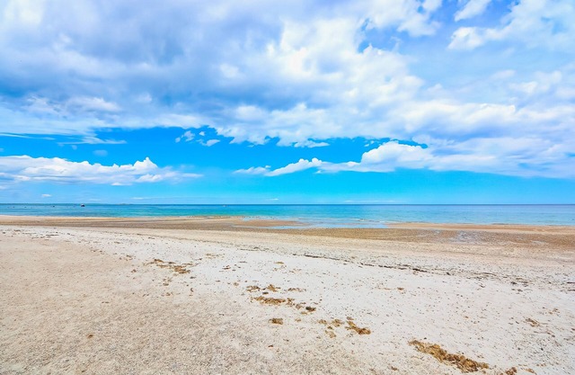 Two-story home near the beach with spacious deck, grill, modern kitchen, & W/D