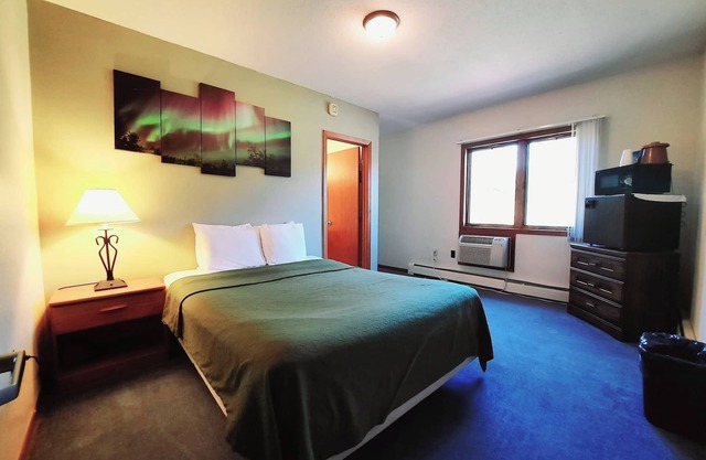 Unique Northern Lights Themed Guestroom inside the Lodge at North Ironwood Acres for up to Four people. 2 Queens, 2 Bathrooms. Dog Friendly resort!