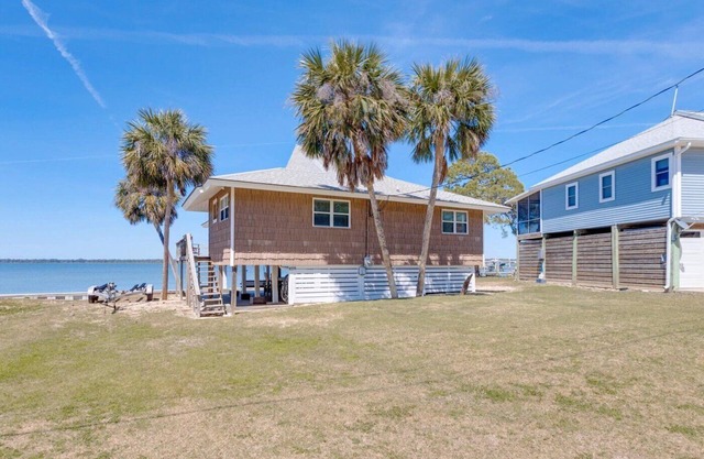 Updated Alligator Point bay front home with dock. Great water and sunset views!