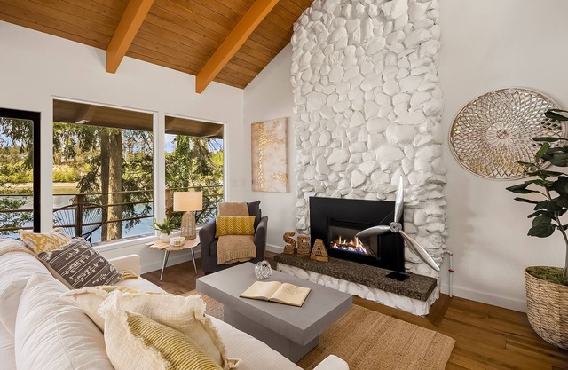 Updated beachfront home with private beach, water views, spacious deck, & W/D