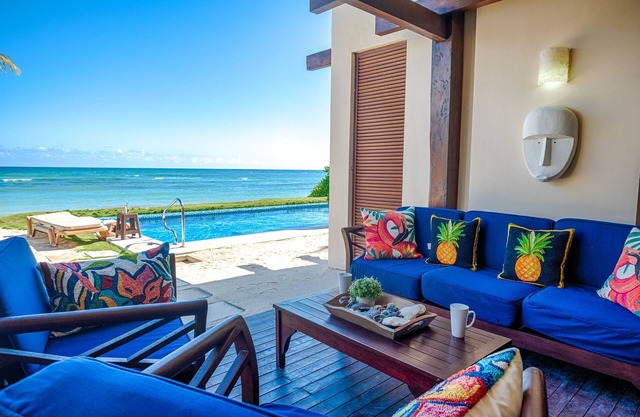 Upscale beachfront ground level condo with AC, WiFi, swimming pool!
