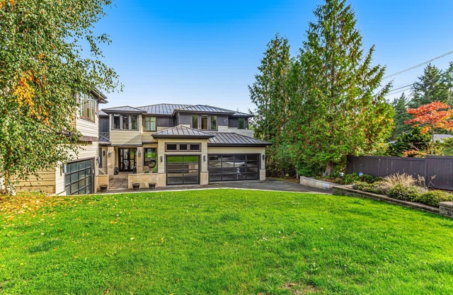Upscale waterfront estate with private beach, dock, fireplace, & gourmet kitchen