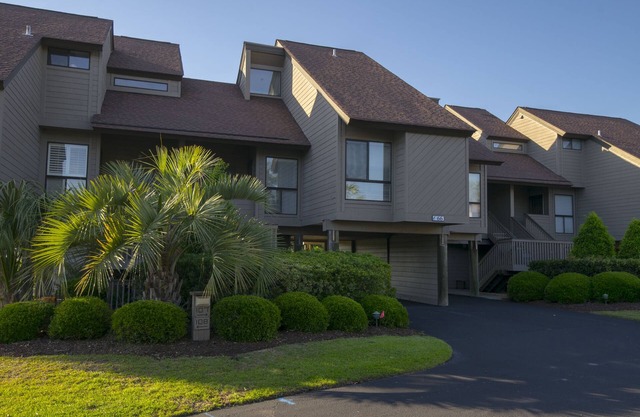 Villa with lake/marsh views and pool access located within gated Litchfield By the Sea community.