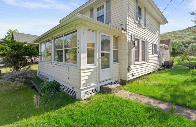 Water view home with a wood stove, grill, & partial air-conditioning - dogs ok