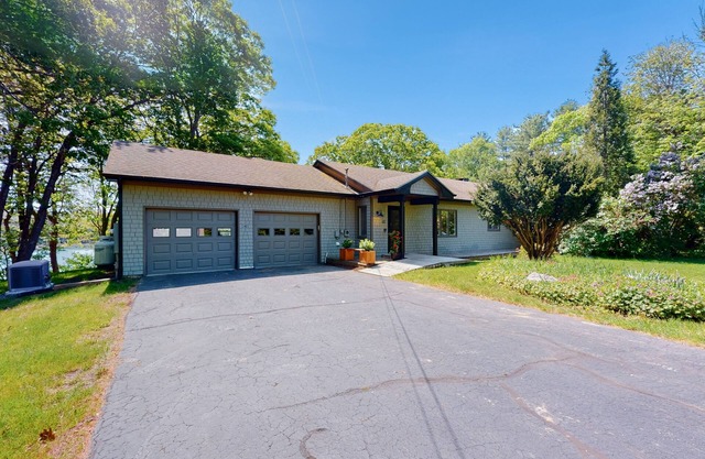 Water-view retreat with beach access, deck, grill, EV charger & lawn games