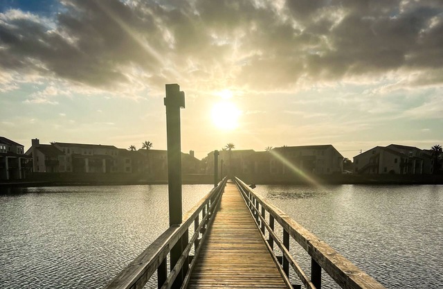Waterfront condo with bay view, outdoor pool, tennis, dock, balcony, W/D, & AC
