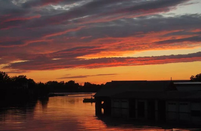 Waterfront Home with dock and a sunset view