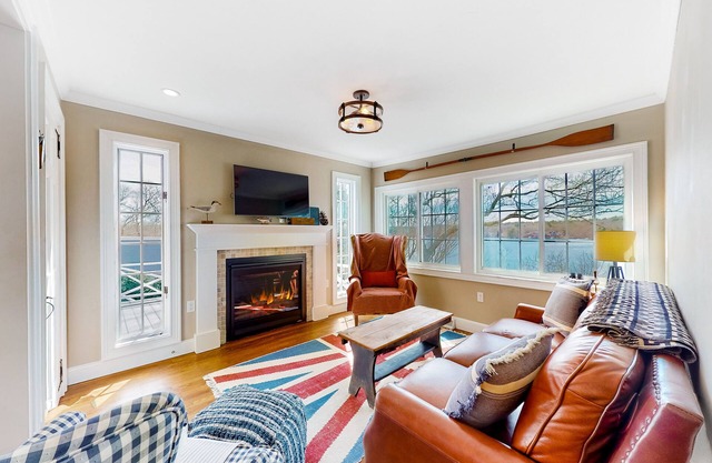 Waterfront home with private beach & dock, water views, deck, & fireplace