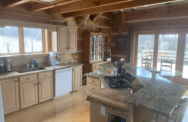 Waterfront log home on Lake Dore. Decks, dock, outdoor hot tub and fire pit.