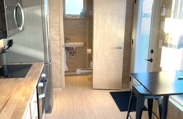 XL tiny home with two lofted queen beds and full size futon on the main level.