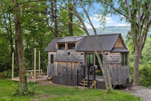 Johnson Haus | Caboose Tiny Home on river with hot tub near Stowe