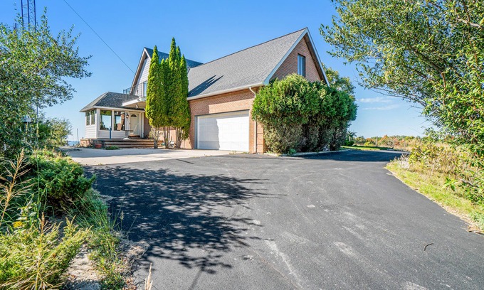 Arcadia Haus | Dog-friendly, lake view home with three season room, fireplace, video projector