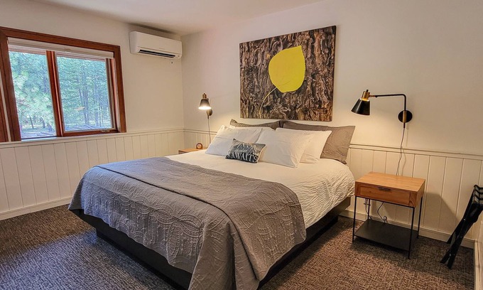 Mazama Haus | Fir - king bedroom with couch at The Inn At Mazama