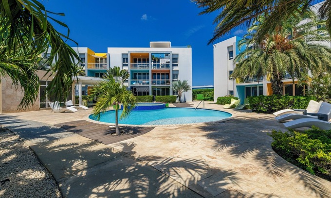 Boegoeroei Eigentumswohnung | Gated community with resort-style amenities - 2 bedroom, 2 bath with an open concept living room and kitchen. Private balcony overlooks pool area.