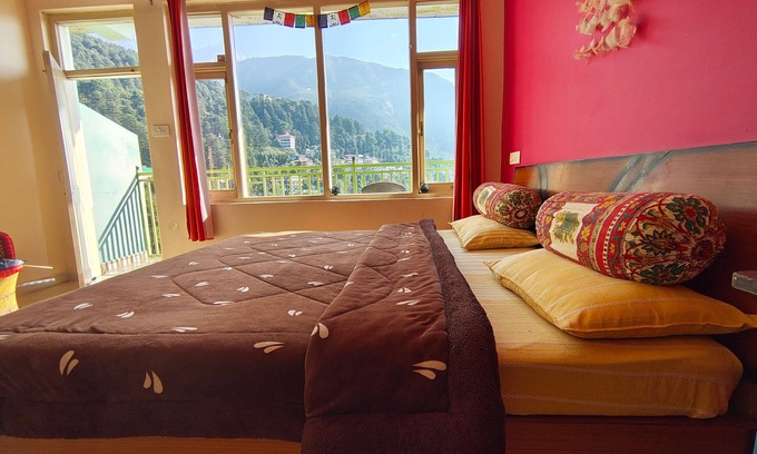 Dharamshala Bed & Breakfast | Golden View BnB Mcleodganj Room with private balcony facing mountain view.